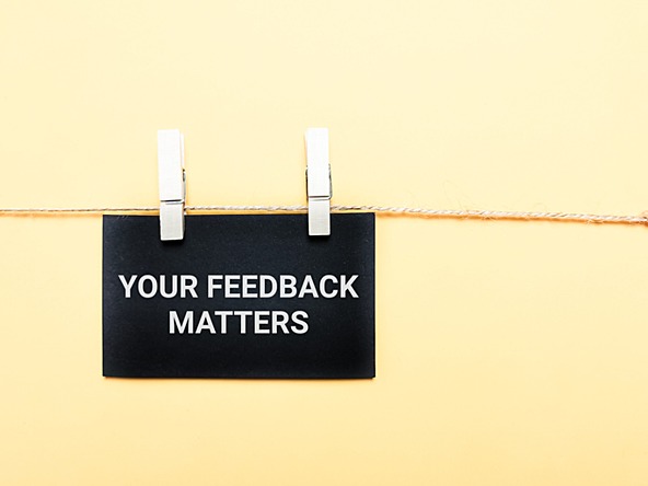 sign pegged on a piece of string, saying 'your feedback matters'